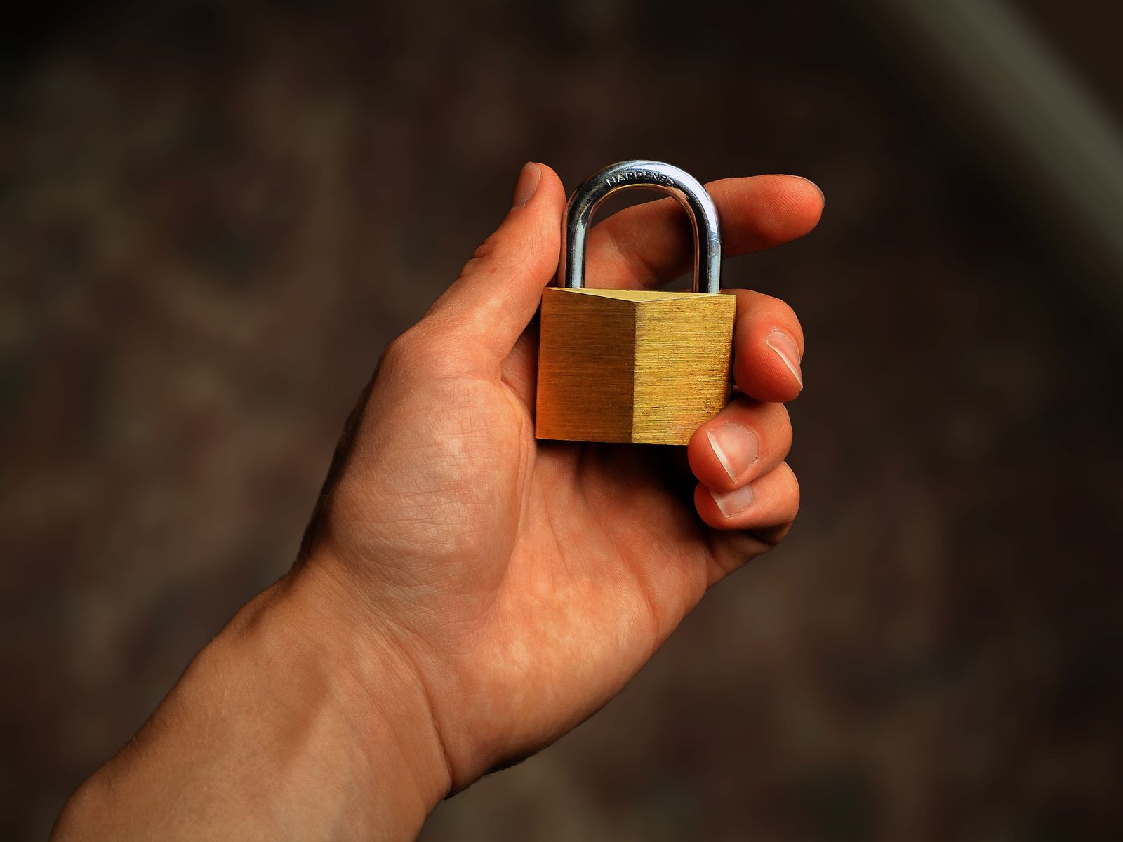 Hand holding a padlock